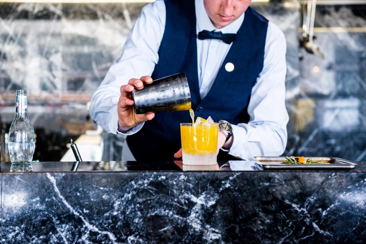 Boscolo Lyon Hotel & Spa Exterior photo A bartender mixing a cocktail